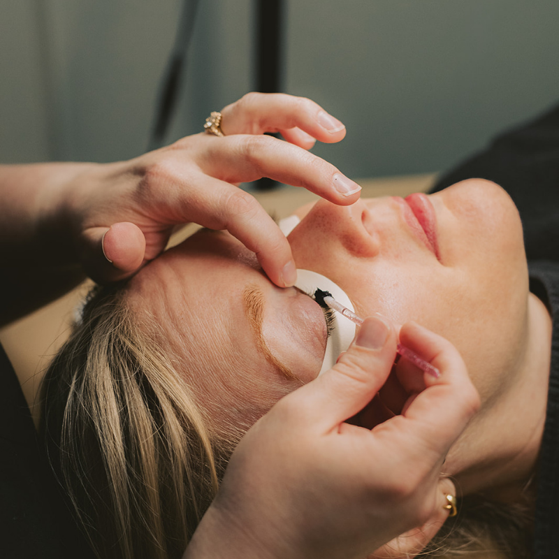 woman having eyelash tint put on her eye